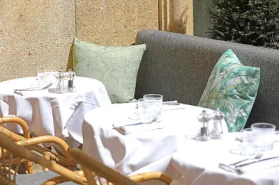 two tables with white table cloths and glasses on them at Negrecoste Hôtel & Spa in Aix-en-Provence