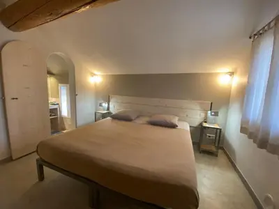 a bedroom with a large bed with two pillows on it at L'atelier B&B in Bédoin