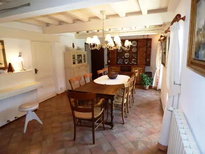 a dining room with a table and chairs at Semi-detached provencal farm with swimming pool in Orgon