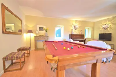 a living room with a pool table in it at Ferme St Roch in Robion en Luberon