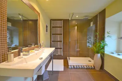 a bathroom with two sinks and a shower and a tub at Ferme St Roch in Robion en Luberon