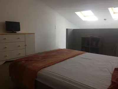 a bedroom with a bed and a dresser with a television at Au bon logis Luberon 50m2 in Cheval-Blanc