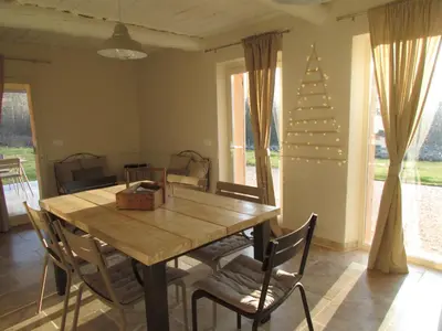 a dining room with a table and chairs and a christmas tree at le bastidon in Villars