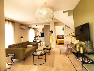a living room with a couch and a table at Les Loges En Provence 