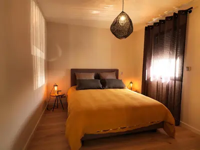 a bedroom with a bed with a yellow blanket at Les Loges En Provence 
