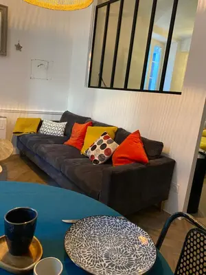 a living room with a couch with colorful pillows at Le cœur de Lourmarin Loulou en Luberon in Lourmarin