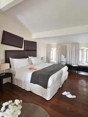 a large bedroom with a large white bed and wooden floors at La Maison d'Aix 1785 - Hôtel Particulier & Spa in Aix-en-Provence