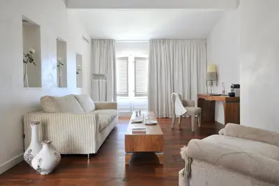 a living room with a couch and a table at La Maison d'Aix 1785 - Hôtel Particulier & Spa in Aix-en-Provence