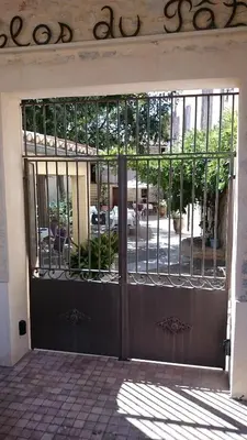 an entrance to a building with a wrought iron door at le clos du Patre in Caromb