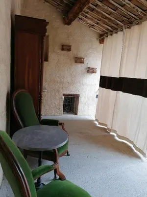 a room with chairs and a table and a window at le clos du Patre in Caromb