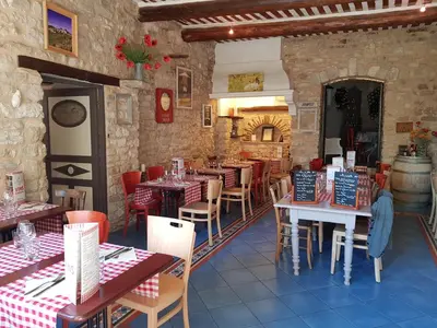 a restaurant with tables and chairs in a room at Le Crillon in Murs
