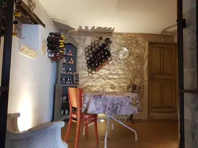 a room with a table with wine bottles on the wall at Le Crillon in Murs