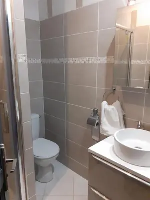 a bathroom with a toilet and a sink at Villa Jasmin in Carpentras