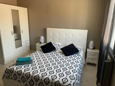 a bedroom with a large white bed with two pillows at Villa Jasmin in Carpentras