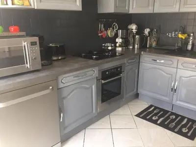 a kitchen with gray appliances and a counter top at Villa Jasmin in Carpentras