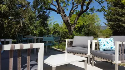 a group of chairs and tables on a patio at Mas des Mûriers in Saumane-de-Vaucluse