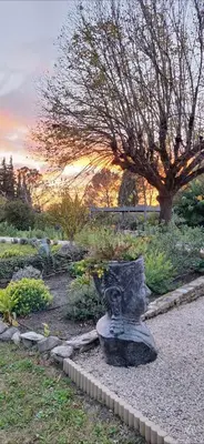 a statue sitting in the middle of a garden at Mas des Mûriers in Saumane-de-Vaucluse