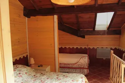 a bedroom in a log cabin with a bunk bed at Mas Michel et Josiane in Monteux