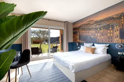 a bedroom with a large bed and a large window at Hôtel La Perna in Pernes-les-Fontaines