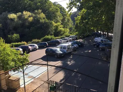 a view of a parking lot with cars parked at Séjour Authentique et provençal in Fontaine-de-Vaucluse