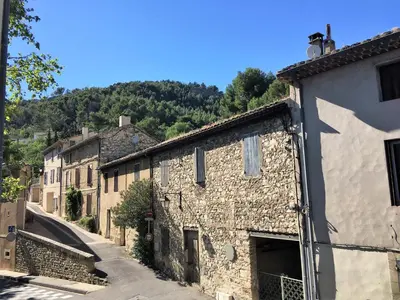 an alley of stone buildings in a village at Séjour Authentique et provençal in Fontaine-de-Vaucluse