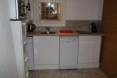 a small kitchen with a sink and a microwave at La Bignone in LʼIsle-sur-la-Sorgue