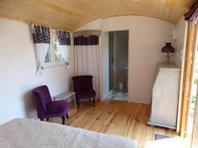 a bedroom with a bed and two chairs in a room at L'Oustau de Bigatié in Lambesc