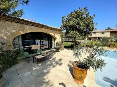 a patio with a table and chairs and a pool at Mas au Cœur de La Provence & SPA in Saint-Cannat