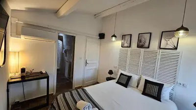a bedroom with a large white bed with two pillows at Mas au Cœur de La Provence & SPA in Saint-Cannat