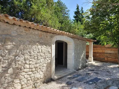 a stone building with a door in the side of it at Mas au Cœur de La Provence & SPA in Saint-Cannat
