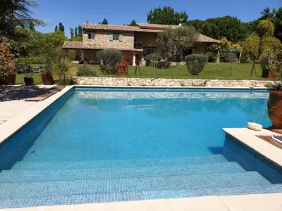 a swimming pool in front of a house at Mas au Cœur de La Provence & SPA in Saint-Cannat