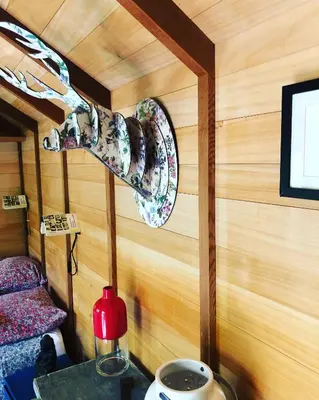 a room with a plate on a wall with a table at Les cabanes de Vallis Clausa in Saumane-de-Vaucluse