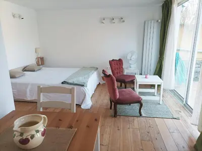 a bedroom with a bed and a chair and a table at 1001 Ocres in Apt