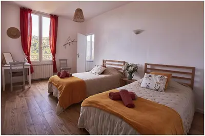 a bedroom with two beds and a desk and a window at 1001 Ocres in Apt