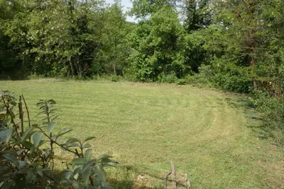 a field of grass with a dirt road at Villa Les Carlets in Saignon