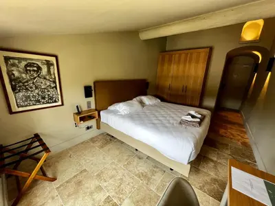 a bedroom with a white bed in a room at Hotel La Bastide d'Eygalières in Eygalières