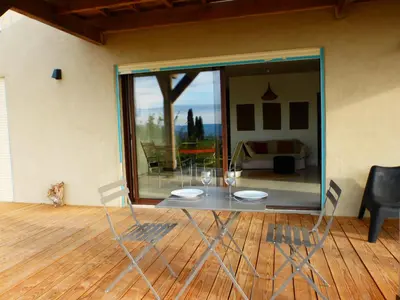 a glass table and chairs in a room with a view at Maison Itzé in Saint-Saturnin-les-Apt