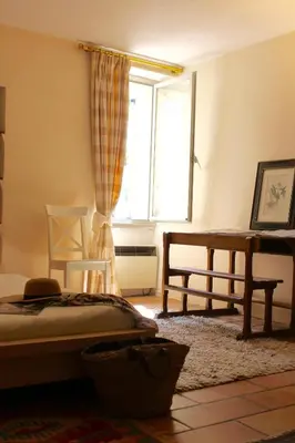a bedroom with a bed and a window at Mas de la Gonnette in Venasque