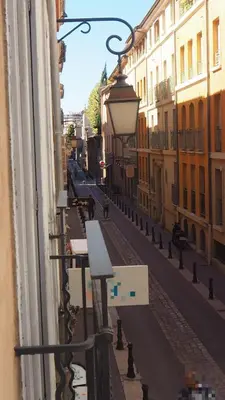 a view of a street from a window of a building at APPART AIX MAZARIN in Aix-en-Provence