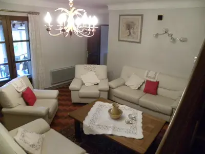 a living room with white furniture and a chandelier at Les Vallons Holiday Home in Lioux