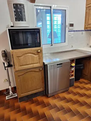 a kitchen with a microwave and a counter with a dishwasher at Les Vallons Holiday Home in Lioux