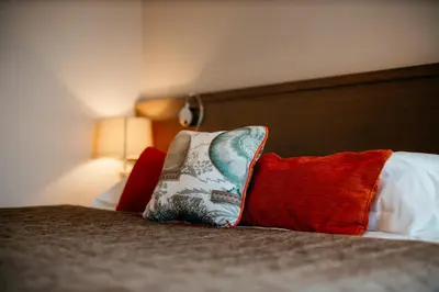 a pillow sitting on top of a bed at Hôtel Carcarille Restaurant Le C in Gordes