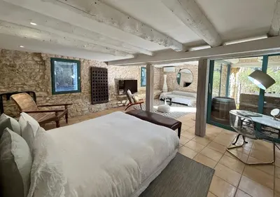 a bedroom with a bed and a living room at La Belugue in Beaumont-de-Pertuis