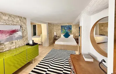 a room with a bedroom with a bed and a mirror at La Belugue in Beaumont-de-Pertuis
