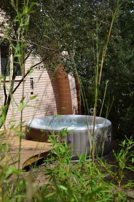 a large bath tub sitting in a garden at Cabanons Jour & Nuit in Mazan