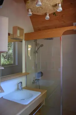 a bathroom with a sink and a shower at Cabanons Jour & Nuit in Mazan