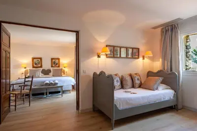 a bedroom with a mirror and a bed and a bed at Le Phébus & Spa – Relais & Châteaux in Joucas
