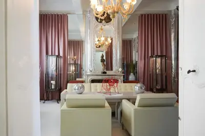 a living room with a couch and a table and chairs at Hôtel Particulier Le 28 - Spa & Art Luxury Design in Aix-en-Provence