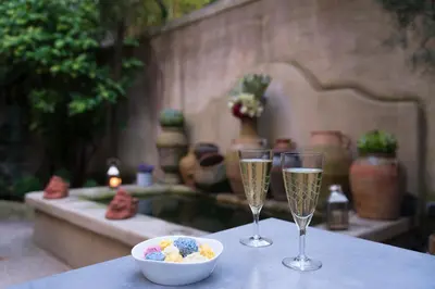two glasses of champagne and a bowl of food on a table at Hôtel Particulier Le 28 - Spa & Art Luxury Design in Aix-en-Provence