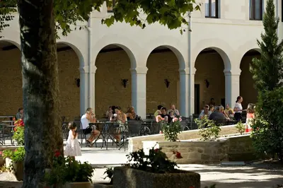 a group of people sitting at tables in a building at Hôtellerie Notre Dame de Lumières in Goult